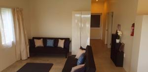 a living room with a couch and a window at Muri Pittman Sunrise in Titikaweka +4 photos