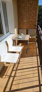 a patio with a table and chairs on a balcony at Apartament Gdynia Babie Doły in Gdynia