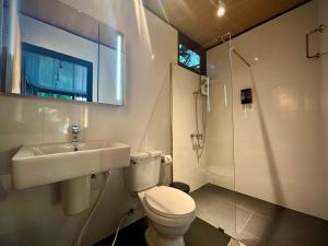 a bathroom with a toilet and a sink and a shower at Kalani, Haad Yao in Haad Yao +28 photos
