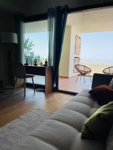 een woonkamer met een bank en een groot glazen raam bij Your dream is real in La Cala de Mijas