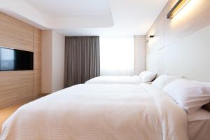 Łóżko lub łóżka w pokoju w obiekcie Acube Hotel Dongdaemun