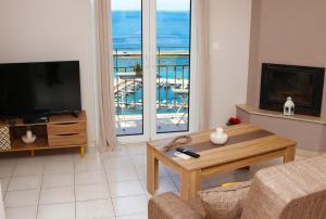 a living room with a view of the ocean at Dimitris House in Plomarion