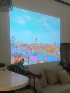 a living room with a large mural on the wall at H'homestay quận 1 - N7 in Ho Chi Minh City