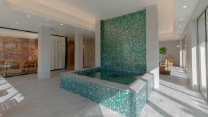 a swimming pool in a house with a green wall at VacationClub Apartamenty Zakopiańskie Apart 314 in Zakopane