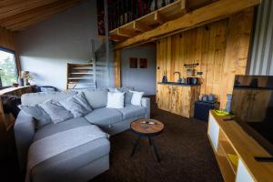 a living room with a couch and a table at De Perenhoeve in Ruinerwold
