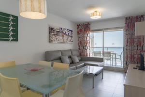 a living room with a couch and a table at Apartamentos Hipocampos Calpe Rent Apart in Calpe