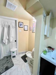 a bathroom with a white toilet and a sink at Private Room Near Airport K8 in Mississauga