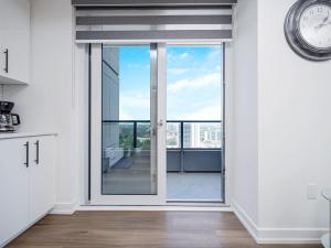 a kitchen with a sliding glass door to a balcony at City View 1BR Condo - King Bed & Private Balcony in Kitchener +16 photos