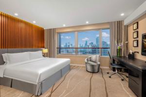 Una habitación de hotel con una cama, un escritorio y una ventana. en Ascott Huai Hai Road Shanghai, Xintiandi, en Shanghái