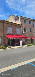 a hotel on the side of a city street at Hôtel Restaurant Les Alizes Loriol Le Pouzin in Le Pouzin