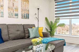 a living room with a couch and a table at Luxury 1BR King Bed Unit - Private Balcony in Kitchener +17 photos