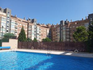 a large swimming pool in front of a building at Madrid Las Tablas apartments in Madrid