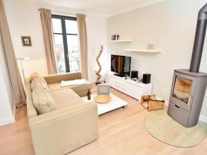 a living room with a couch and a fireplace at Villa Paula - WG03 strandnah mit Kamin, Terrasse, Balkon in Ostseebad Sellin +30 photos