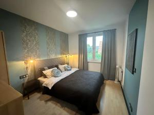 a bedroom with a bed and a window at Dekoratoria Apartments in Kraków