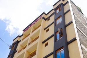 a tall building with the sky in the background at Bethh serviced Apartments in Ruiru