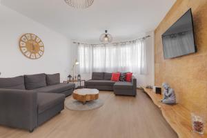 a living room with a couch and a table at La Villa in Tarajalejo