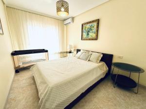 a bedroom with a large bed and a window at Hugo's holiday apartment in Costa del Silencio in Arona +20 photos
