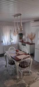 a kitchen with a table and chairs in a room at Villa Eleonas in Makri