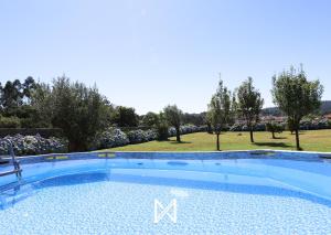 a large swimming pool with the letter m on it at MyStay - Refúgio da Natureza in Monte Córdova