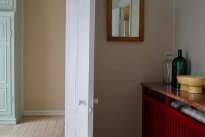 a white door in a room with a counter and a mirror at SJ Apartment in Aarhus