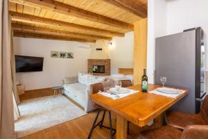 a living room with a table and a couch at Nature Holiday Home in Grižane