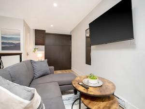 a living room with a couch and a table at Cozy Studio Apt - Corktown Hamilton in Hamilton