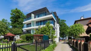 a building with a fence in front of it at VacationClub - Boulevard Residence Apartament 21 in Ustronie Morskie
