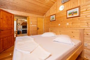 Un dormitorio con dos camas en una cabaña de madera. en Wine Garden House, en Grižane