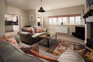 a living room with a couch and a table at Farm Cottage in Berwick-Upon-Tweed