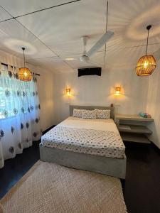 a bedroom with a bed and two pendant lights at Sri Villa Polwatta in Weligama +46 photos