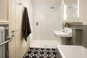 a bathroom with a tub and a sink and a toilet at Farm Cottage in Berwick-Upon-Tweed +20 photos