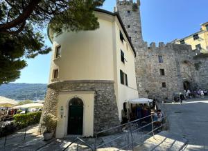 a building in front of a castle at La Casa Rotonda in Portovenere