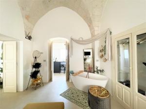 a bathroom with a bath tub in a room at Suite Sami Charming Home in Ostuni