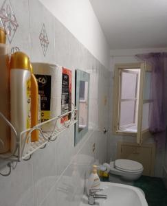 a bathroom with a sink and a toilet at Piccolo borgo antico Cefalù in Cefalù +32 photos