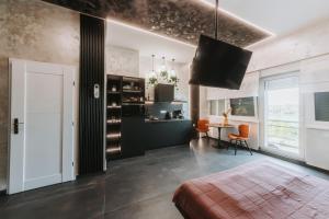 a living room with a television and a dining room at Stari Toranj V studio apartman in Vukovar