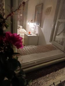 a mirror with a reflection of a table in a room at Latmos 1860 in Skala