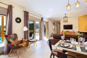 a living room with a couch and a table at Villa Trules in Fotinós
