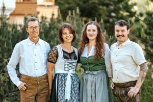 a family posing for a picture in a garden at Apartments Burvel in Selva