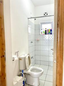 a bathroom with a toilet and a shower at Imali homes in Mombasa