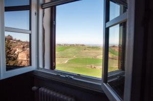 a window with a view of a golf course at Gemma B&B in Paderna