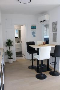 a kitchen and dining room with a table and chairs at Bubi Apartments-Private parking in Zagreb
