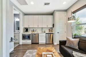 a living room with a couch and a kitchen at Luxury Living Superior Home in Prime Tampa Location in Tampa