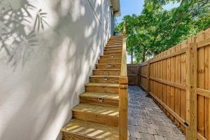 a set of wooden stairs next to a fence at Luxury Living Superior Home in Prime Tampa Location in Tampa