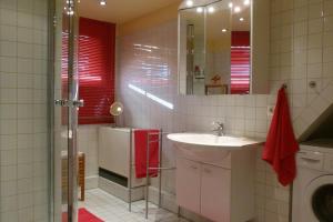 a bathroom with a sink and a refrigerator at Ferienwohnung Faby in Hollern-Twielenfleth