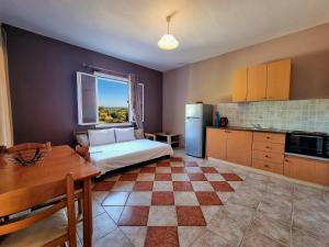 a kitchen with a bed and a table in a room at Maspali Apartments in Lixouri