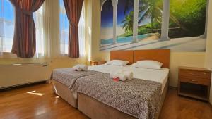 a bedroom with two stuffed animals on a bed at Hostel CANTO in Ruse