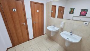 a bathroom with a sink and a toilet and a mirror at Hostel CANTO in Ruse +27 photos