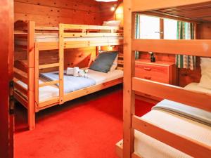 a room with three bunk beds in a cabin at Chalet Mungg by Interhome in Nendaz +32 photos