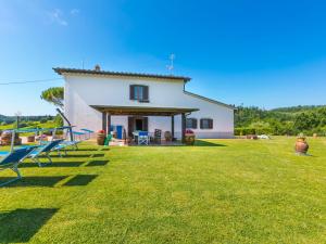a farmhouse with a large yard with chairs at Holiday Home Il Poggetto by Interhome in Mercatale Val Di Pesa
