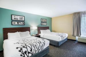 Voodi või voodid majutusasutuse Sleep Inn & Suites Dunmore toas